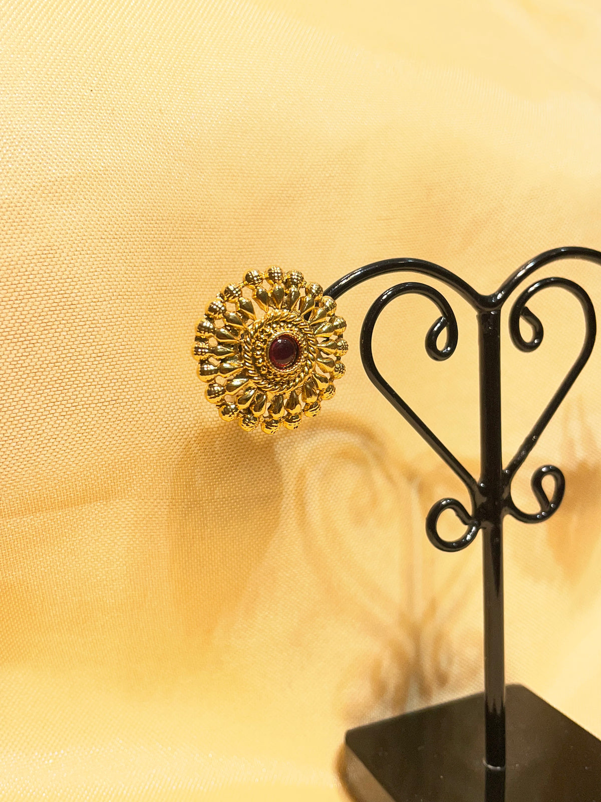 Gold toned traditional floral stud earrings