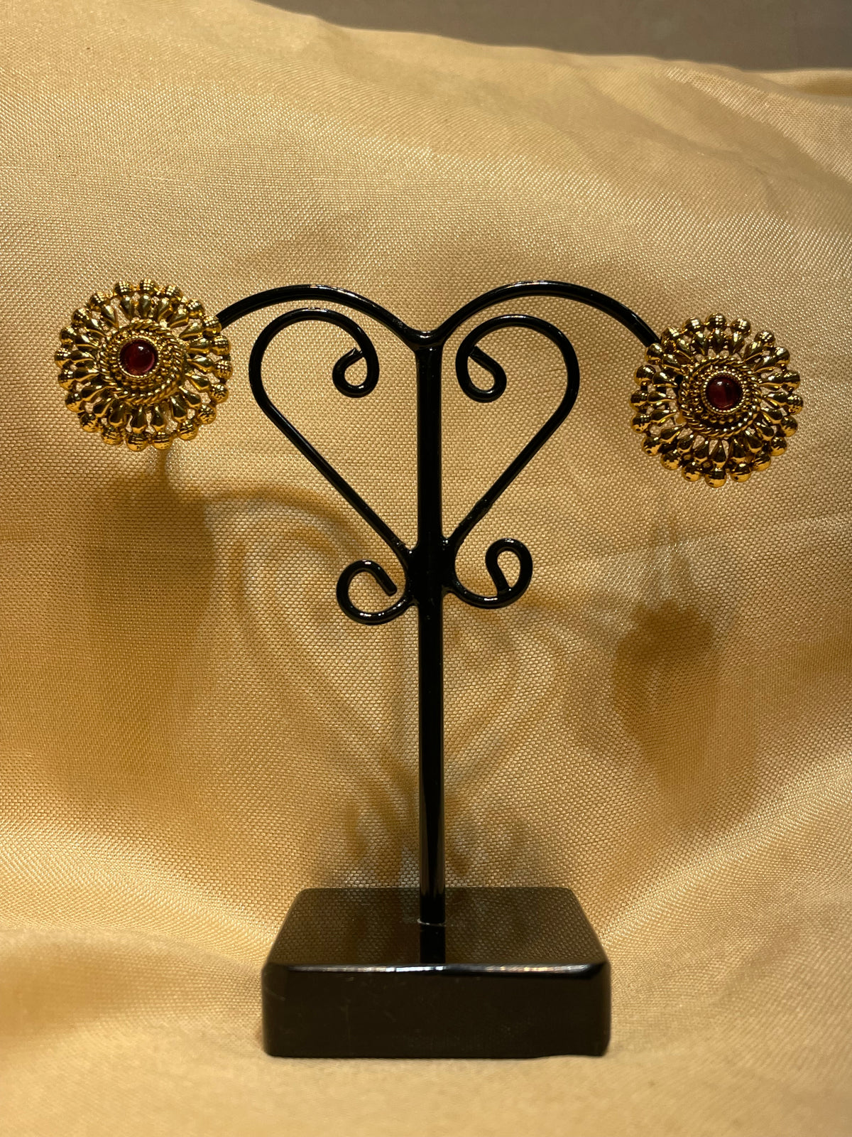 Gold toned traditional floral stud earrings