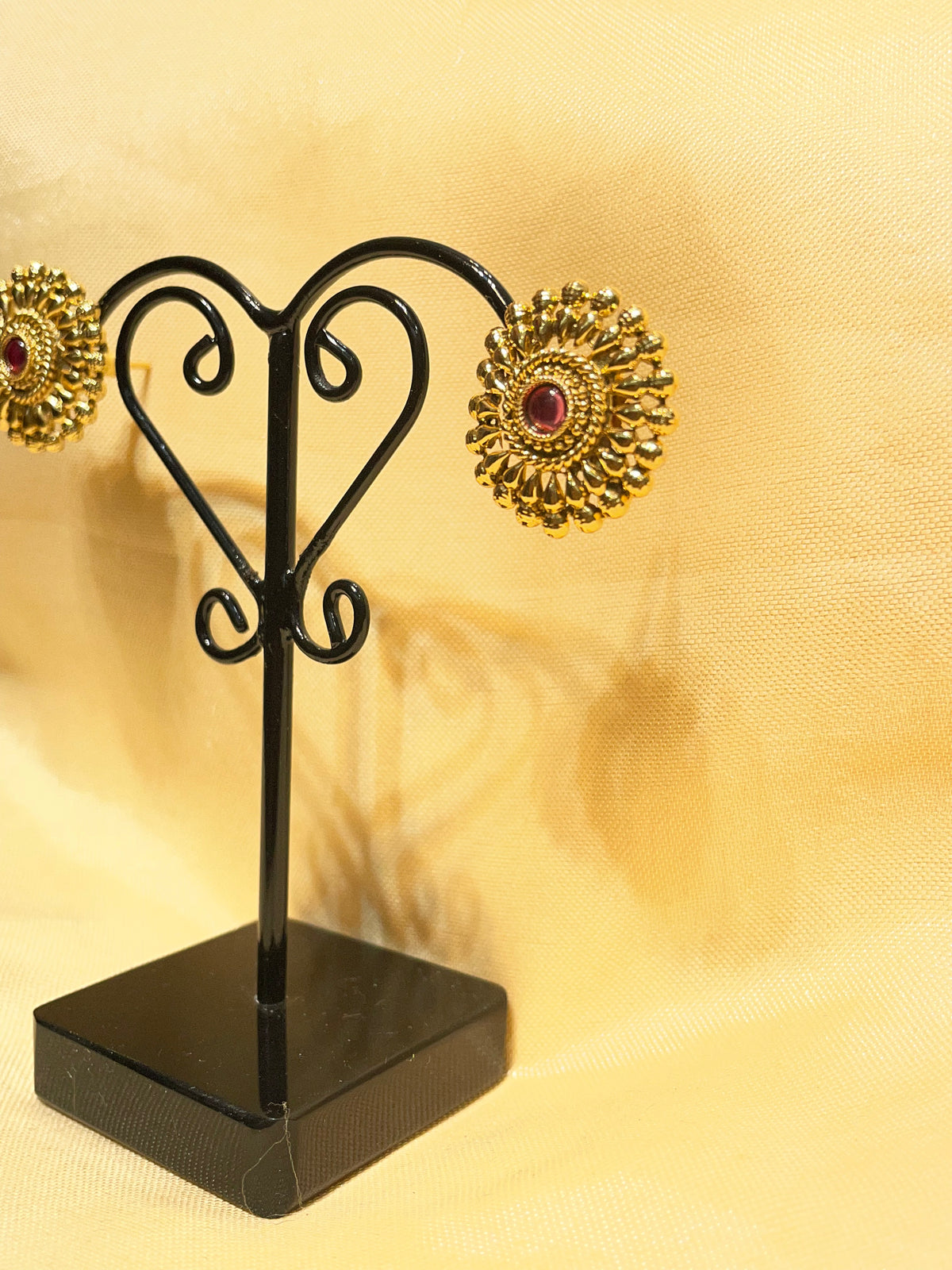 Gold toned traditional floral stud earrings